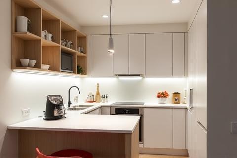Compact yet highly functional kitchen in a Dublin city apartment, maximizing space with clever storage.